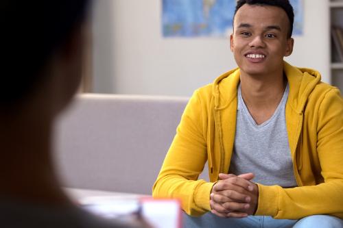 teen speaking with his therapist in a teen process addiction treatment center